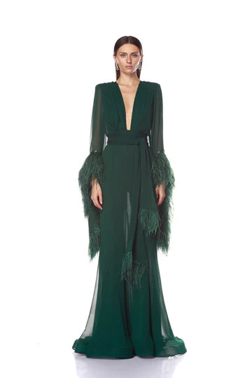 Green evening gown with feathered sleeves on a white background